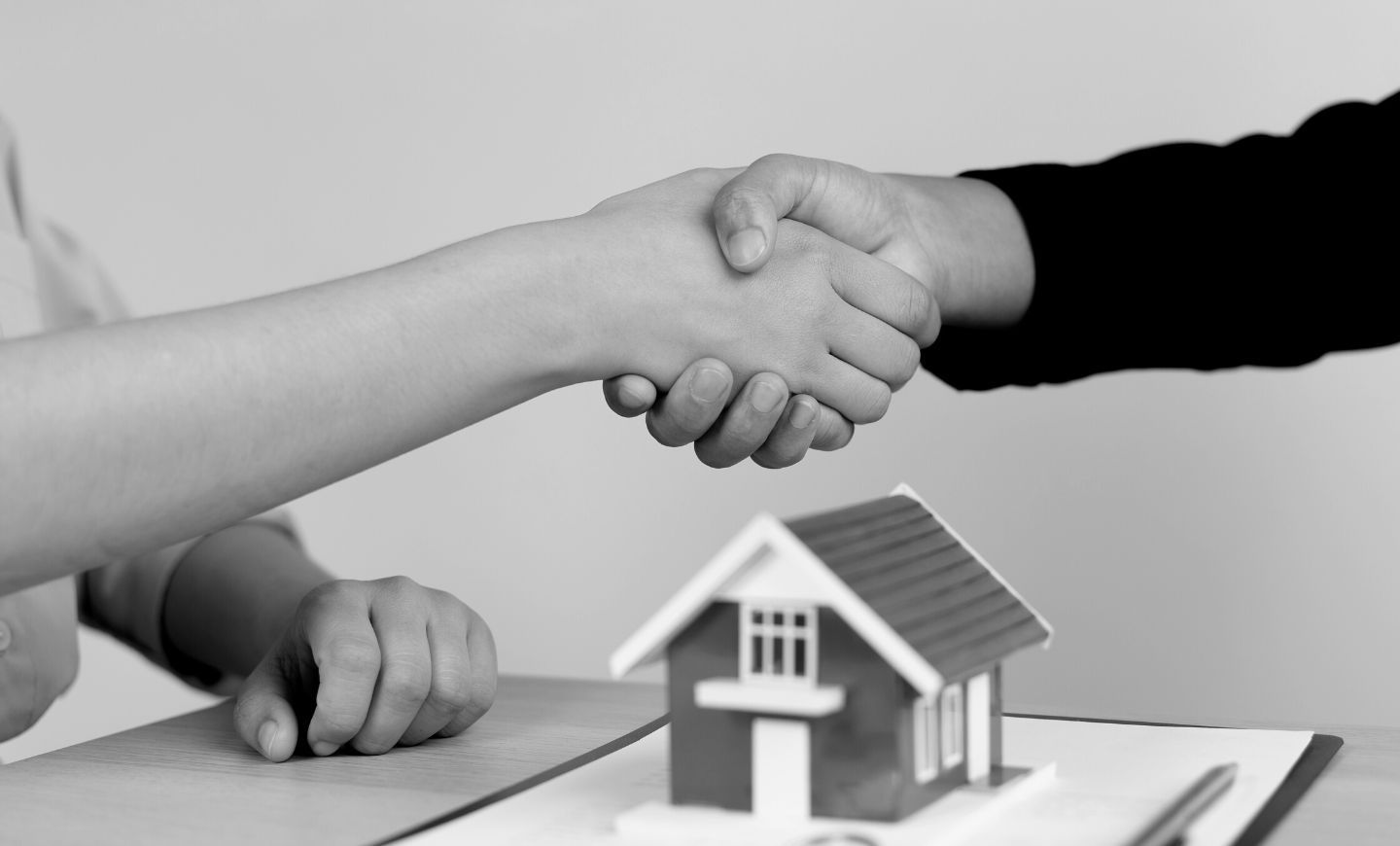 two people closing the contract for the sale of a real estate property